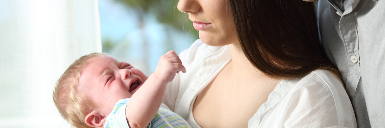 Postpartum Depression, Panic Attacks and Anger parents holding crying baby looking tired or upset