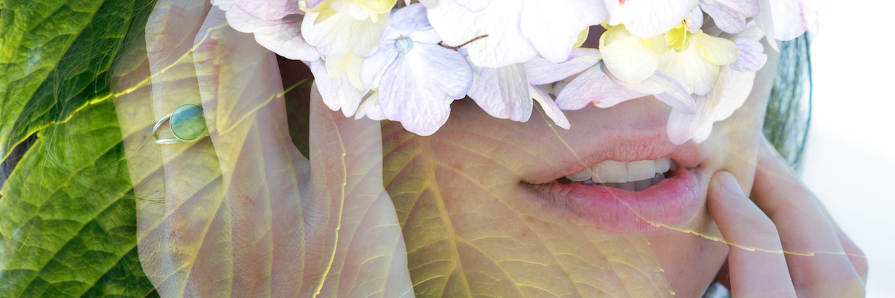 woman with flowers over her face