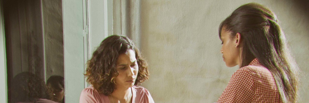 Spreading Awareness About Dystonia Women having tea on hotel patio.