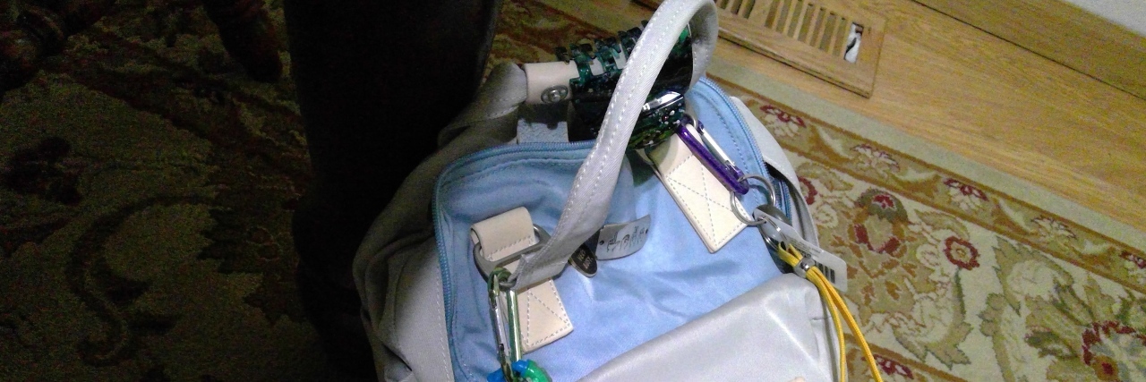 What to Carry With You During the Holidays If You Have Dysautonomia woman's backpack filled with essentials for managing dysautonomia