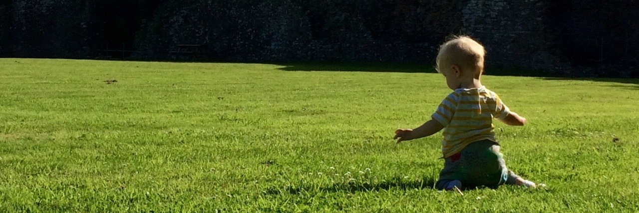 When Strangers Laughed at My Daughter With a Limb Difference Little boy in a large green field