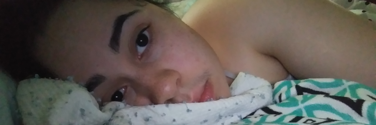 When the Fear of Having Anxiety Manifests as Nightmares woman lays in bed looking sad