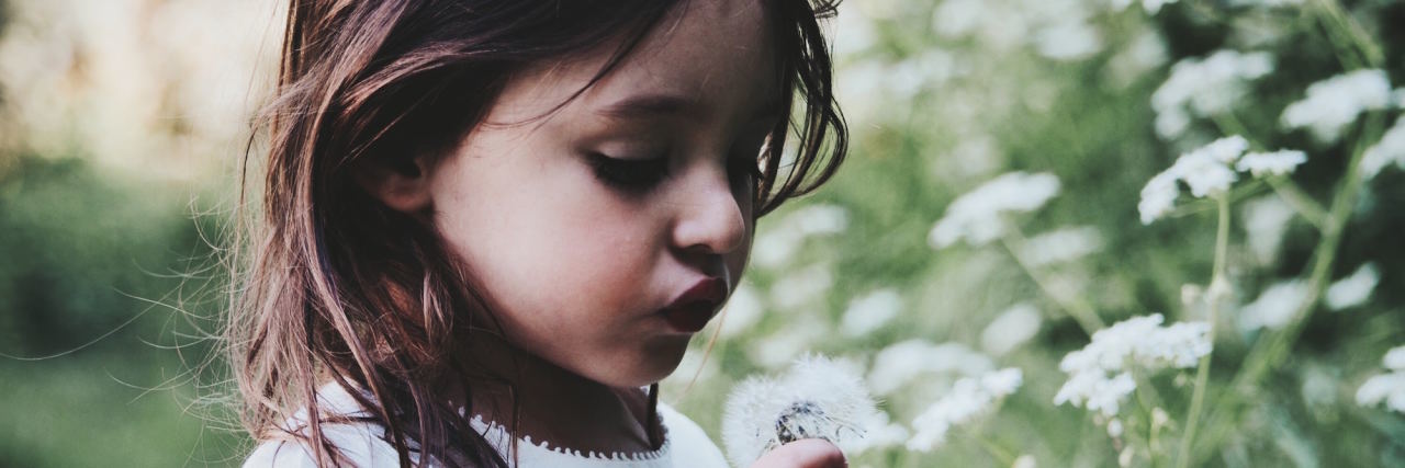 Why I Wish I Knew About My Mom's Bipolar Disorder Diagnosis Growing Up young girl in flowers