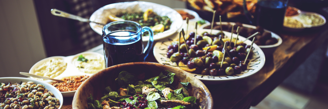 How to Stick to the Autoimmune Paleo Diet Over the Holidays buffet table of bowls of food