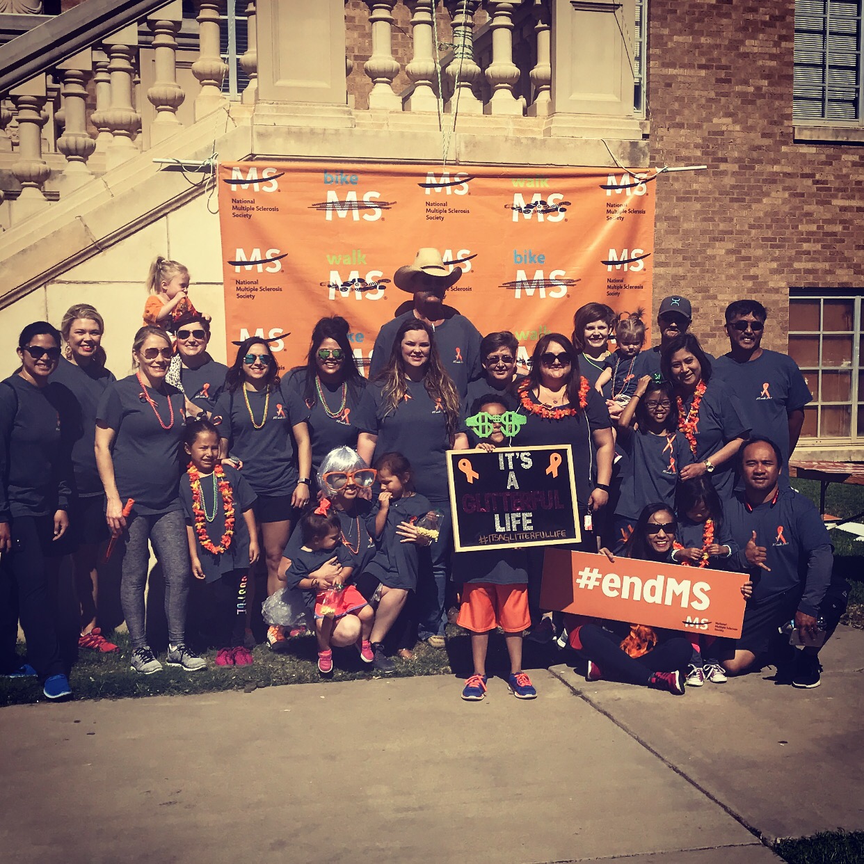 A group of people with signs that read, "#EndMS."