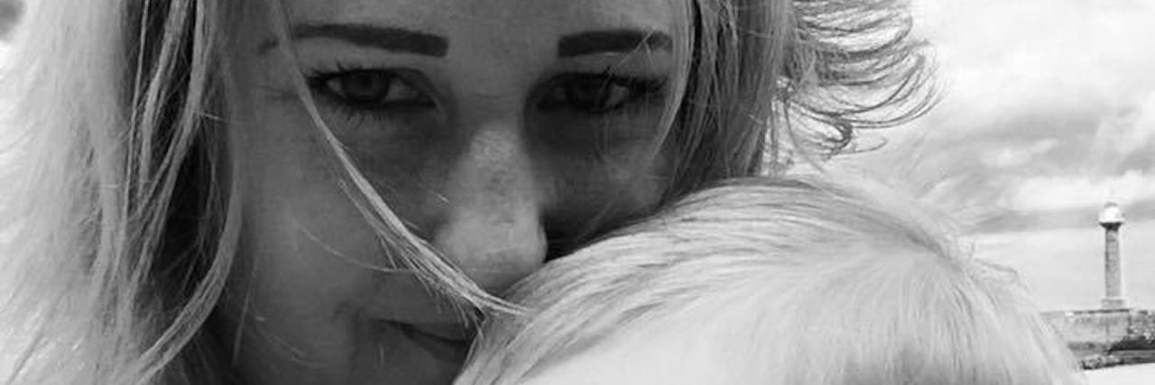 When You're a Mummy Who Struggles With Anxiety and Depression a mom holds her child. picture in black and white