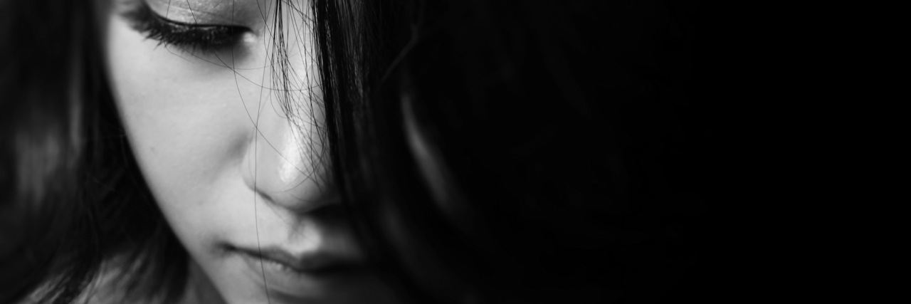 The Emotions and Pain of Interstitial Cysitits black and white photo of woman's face eyes down