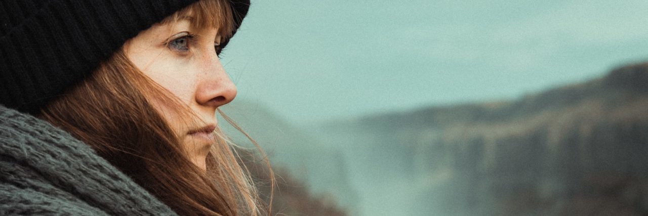 What Can Trigger a Bipolar Mood Swing and How to Combat It woman looking out over countryside pensive