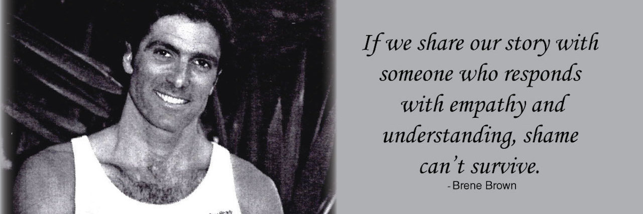 Why Silence Perpetuates Suicide Stigma a man stands with arms crossed and smile. In black and white