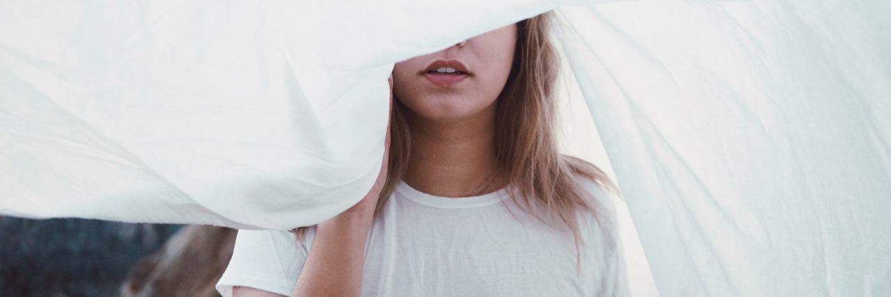 6 Things Anxiety Disguises Itself As woman sheet over eyes