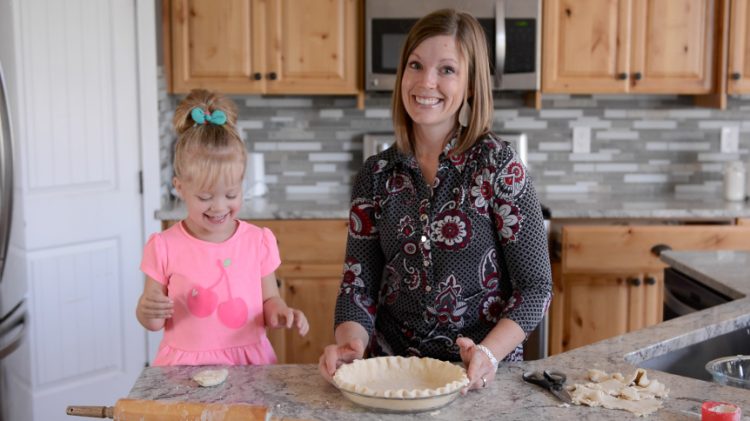 Mel Gunnell with daughter cooking