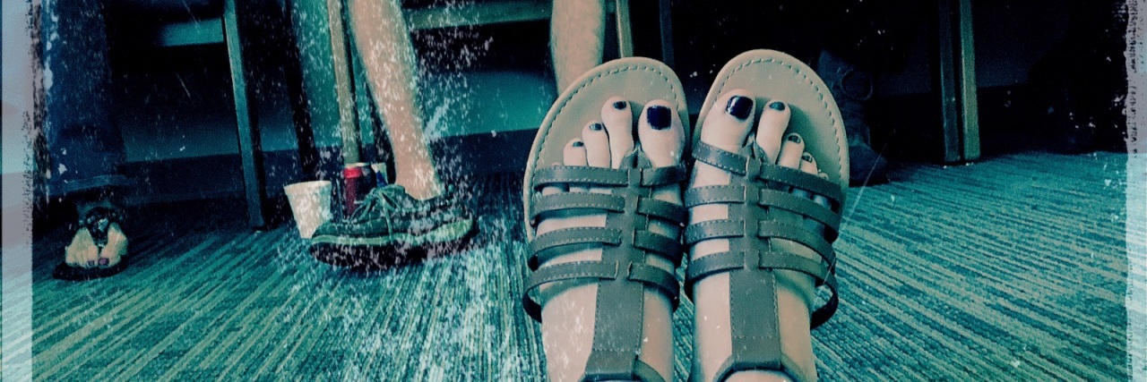 Why Group Therapy Is the Best Christmas Gift I've Been Given woman's outstretched feet on floor of waiting room or group therapy with others facing her