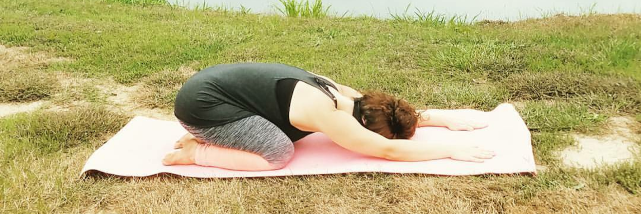 The Yoga Poses That Help With Endometriosis woman doing child's pose