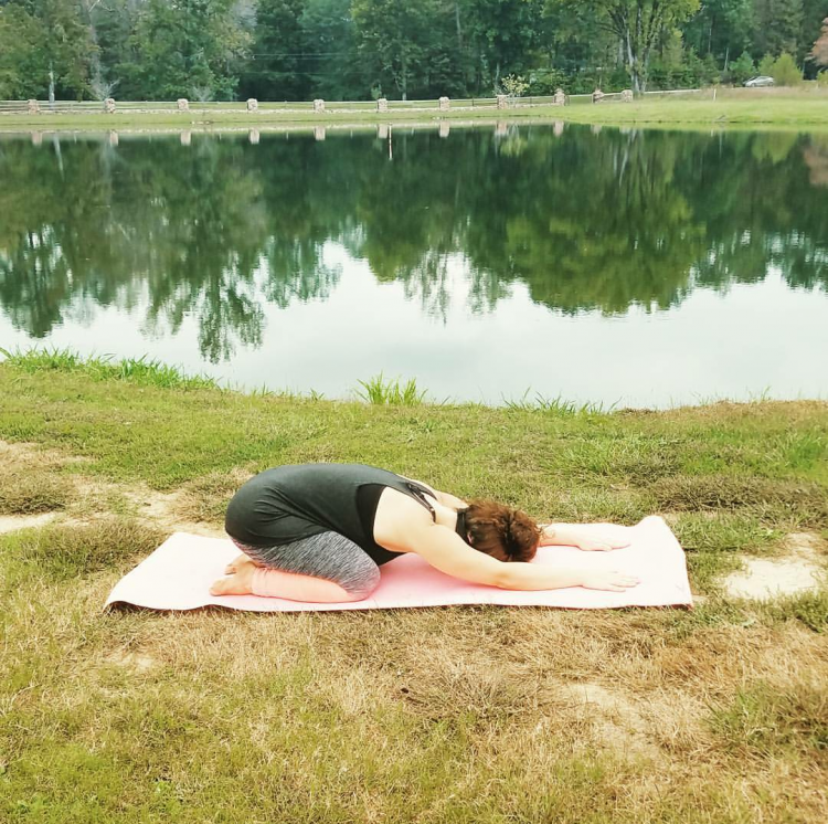 Here Kimberli is practicing Balasana or Childs Pose. This pose helps open her hips, back and even helps with her migraines.