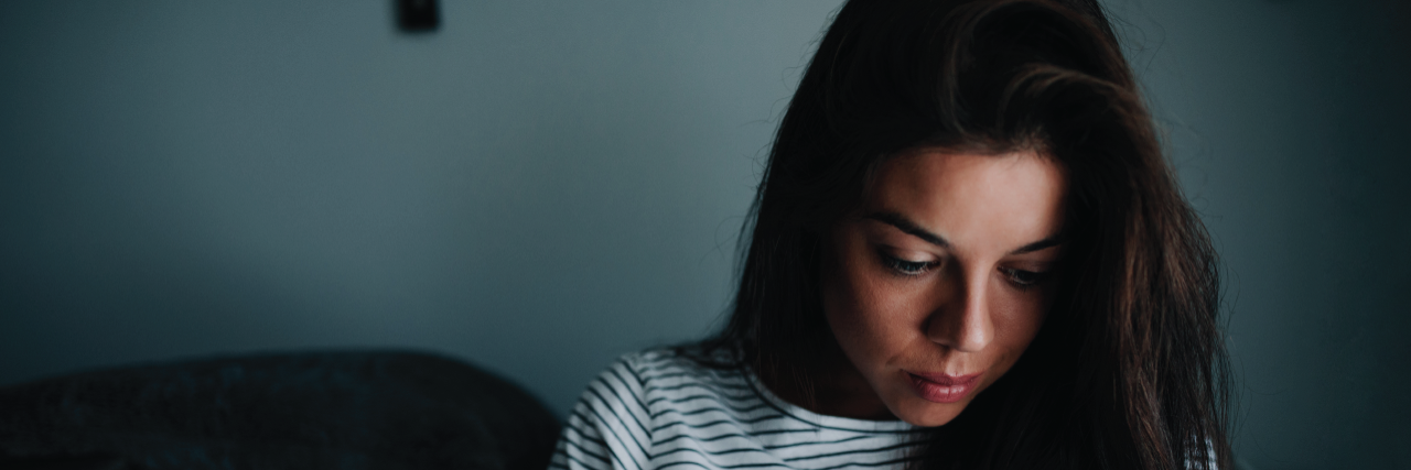 21 Things You Should Expect When I'm Having a Bad Mental Health Day young woman with dark hair looking down