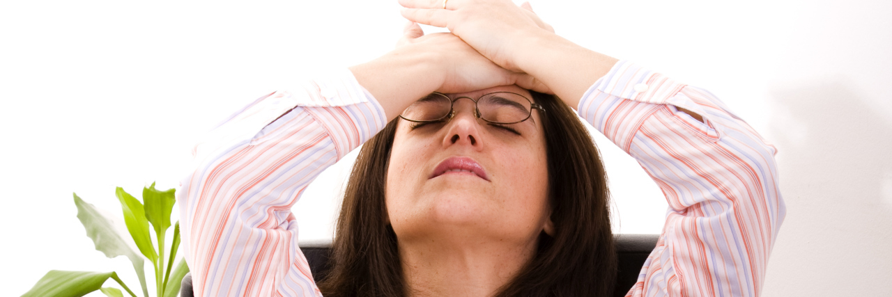 How Sexual Misconduct Reports in the Media Helped Me Speak Out businesswoman at her office stressed with her work