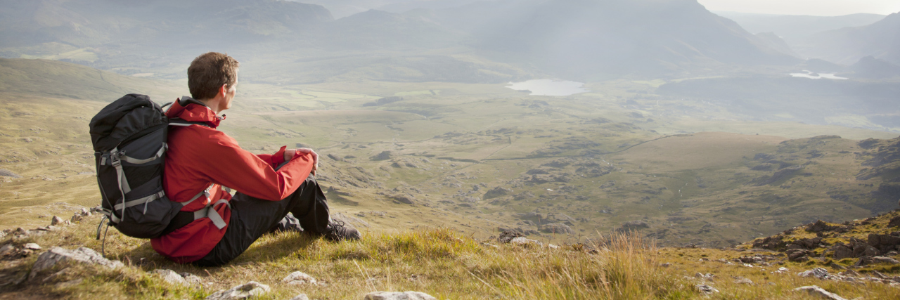 Tips for Moving to a New State With a Mental Illness hiker man overlooking vista from mountain