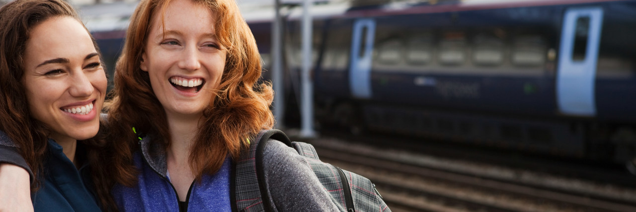 Bonding With People Over Chronic Illness two friends laughing and hugging