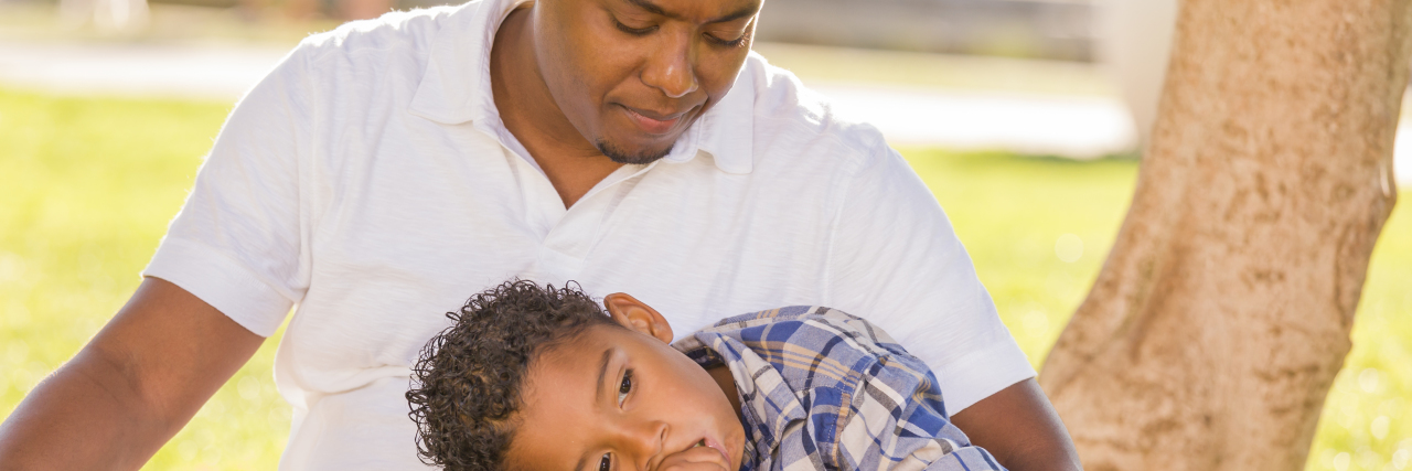 6 Things to Remember After a Young Person Dies by Suicide African American Father Worried About His Mixed Race Son as They Sit in the Park.