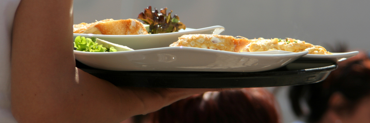 food being served by a waiter during