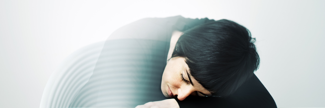 What I Want You to Know About the Grief of Losing Someone to Suicide Young woman having a nap on a table. She's half transparent because she's at half way from her dreams.