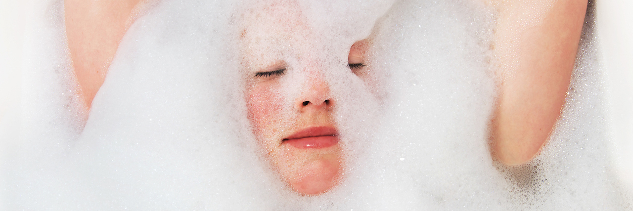 Jenny Trout Tweets Message About Self-Care and Mental Illness young woman taking a foam bath.