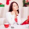 woman in pain on her couch surrounded by christmas presents