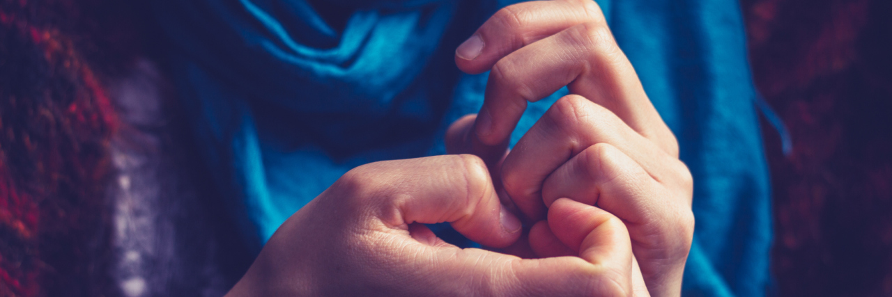 Coming to Terms With Dermatillomania Scars close up of woman picking skin around nails