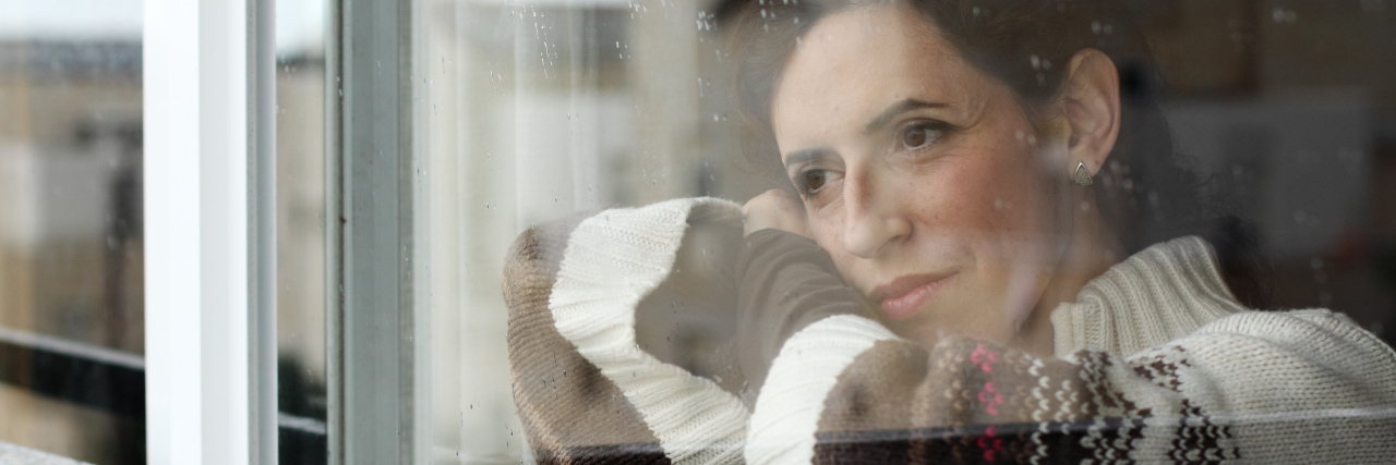 When Depression Robs You of Holiday Spirit Art portrait of a beautiful young sadly girl looking through the window