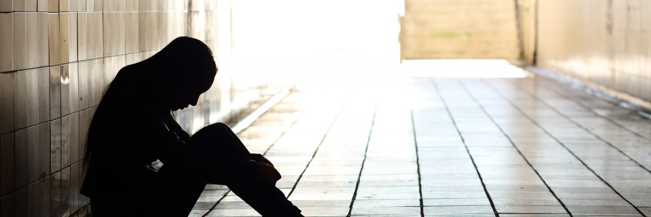 When Chronic Pain Takes Away Your Freedom as a Teenager Backlight of a teenager sitting inside a tunnel at school