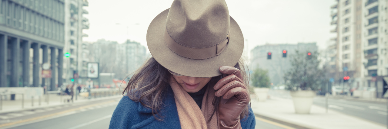 When Someone Questioned My Happiness That Masks My Anxiety eautiful young brunette with hat posing in the city streets