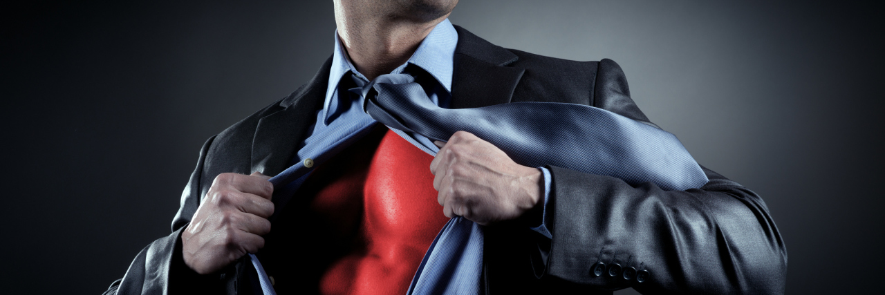 How I Gained 'Superpowers' From My Brain Injury businessman opening shirt to reveal red superhero costume underneath superman pose
