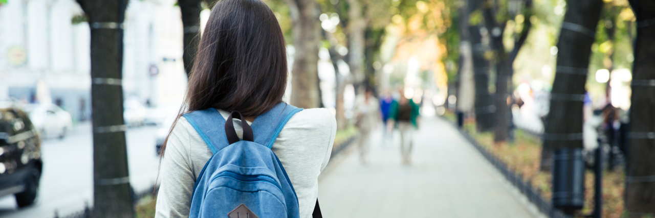 Why I Left My College Athletics Team for My Mental Health Back view portrait of a female student walking in the city park outdoors
