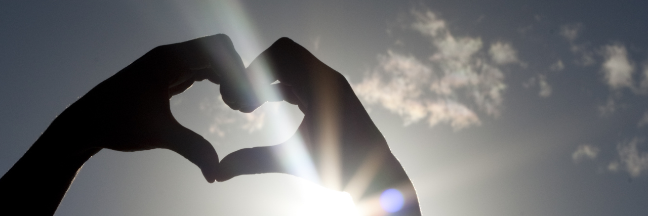 Autism and Empathy Heart Shaped Hands in the sky.