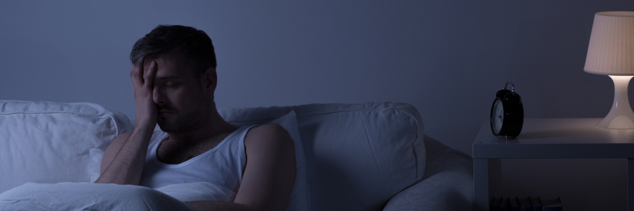 Struggling to Sleep Because of Pain From Fibromyalgia man struggling to fall asleep