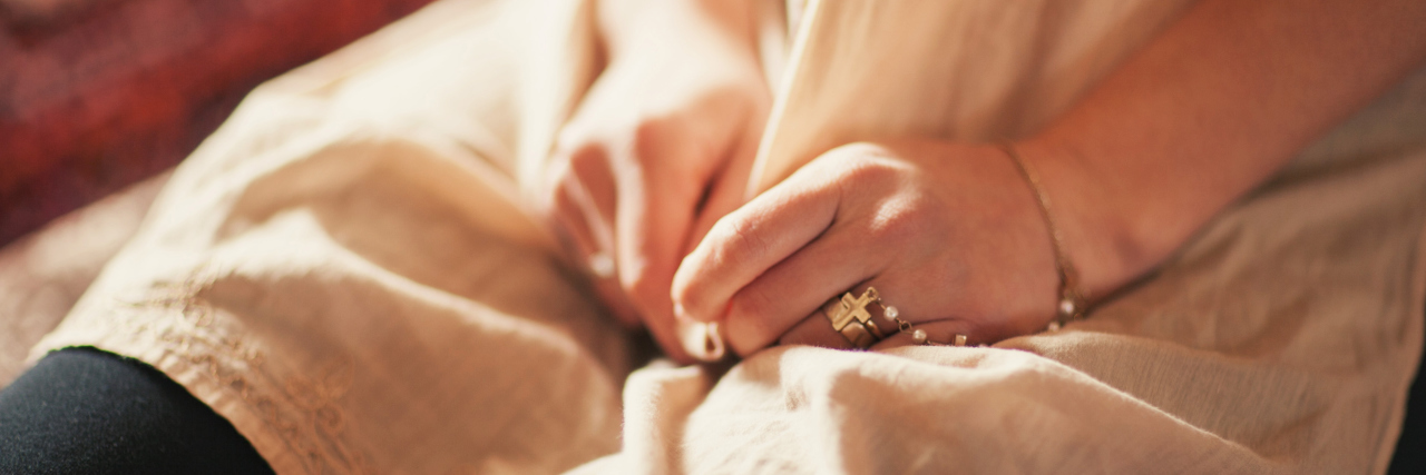 Why Endometriosis Can Be Embarrassing woman's hands in her lap