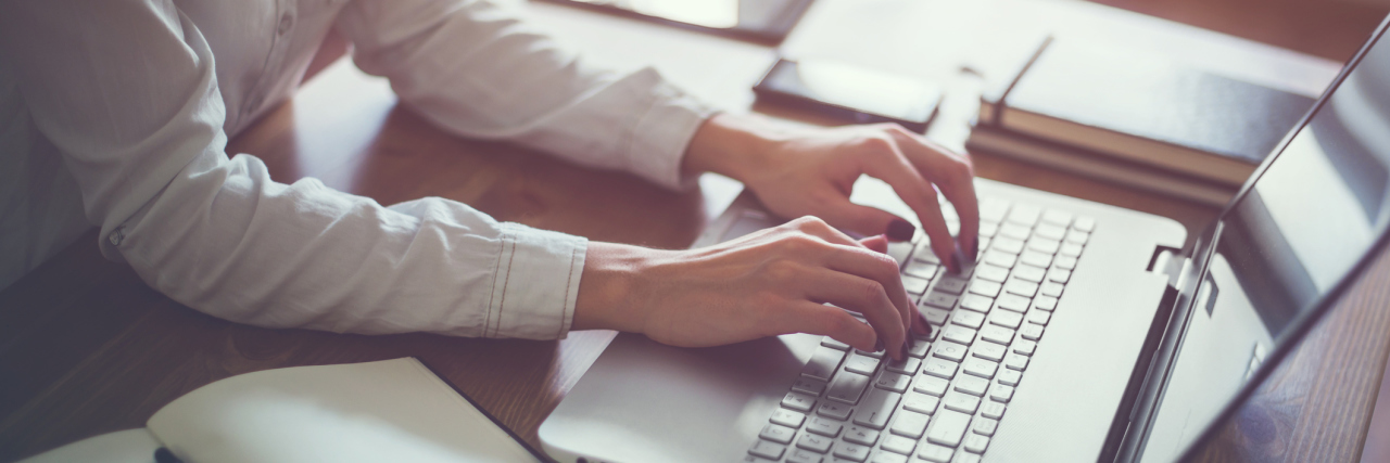 How to Educate Yourself to Live Better With Chronic Illness woman typing on computer