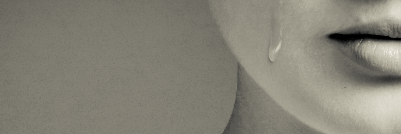 Why the Idea That Mania Is Always a Good Thing Is Wrong close up of woman in sepia tones with tear rolling down cheek
