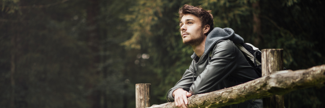 What to Know If You've Just Been Diagnosed With Chronic Lyme Disease man standing outside in nature