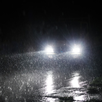 Bright headlights on a rainy night.