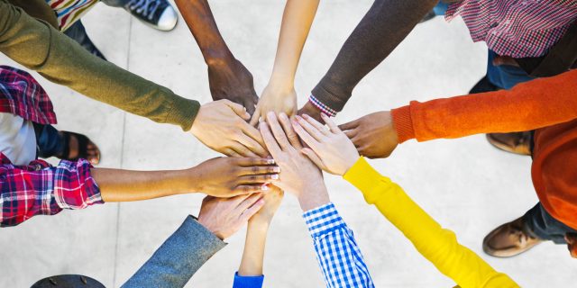What I Want Rare Warriors to Remember for the New Year Group of Diverse Multiethnic People putting hands together to indicate Teamwork