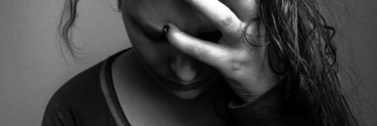 Living With Both Mixed Connective Tissue Disease and Anxiety black and white image of a woman holding her head