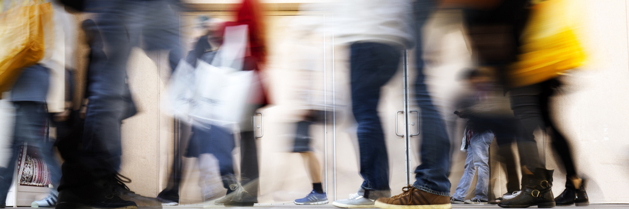 Autism and Sensory Sensitivities Blurry people walking on the sidewalk at rush hour.