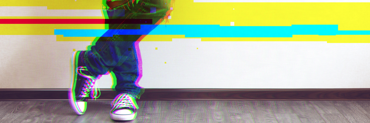 Multiple Sclerosis Affecting Ability to Stand A photo focusing on a man's legs in jeans, wearing converse, with bars going across the image.