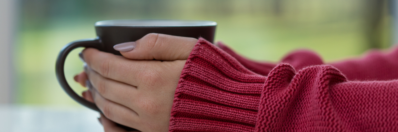 The Effects of Celebrating Christmas on Chronic Pain, Fibromyalgia woman in red sweater holding a mug