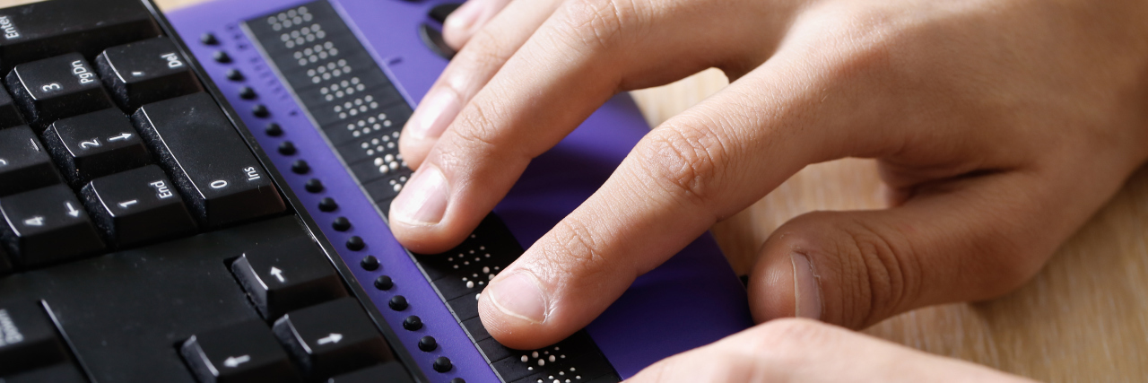 Attending a Deaf and Blind School Changed My Life Blind person using computer with braille display.