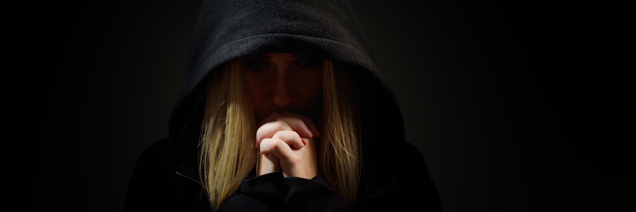 When Bipolar Mania Makes You Fear Spirituality Praying woman in hood. Nun.
