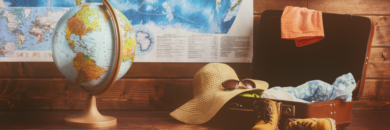 Vacationing Tips for People With Chronic Illness A vintage suitcase, globe, map, and camera.
