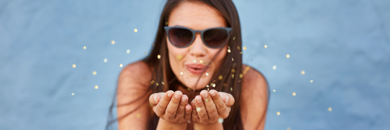 How to Make a New Year's Resolution With a Mental Illness Woman blowing sparkles