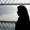 Silhouette girl and bridge over river in autumn